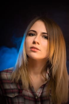 portrait smiling girl on blue background in studio.
