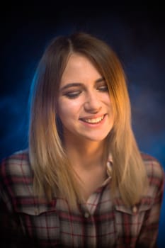 portrait smiling girl on blue background in studio.