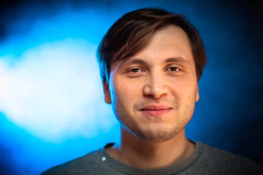 portrait emotional young man on blue background.