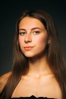 Portrait beautiful girl on a dark studio background.