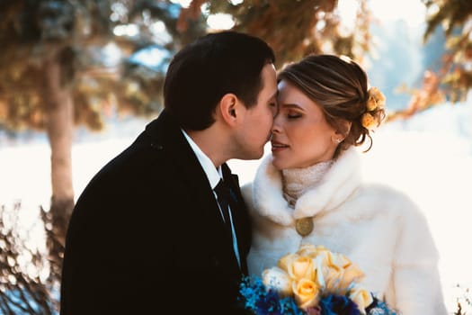 Winter bright wedding bride and groom couple.
