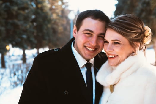 Winter bright wedding bride and groom couple.