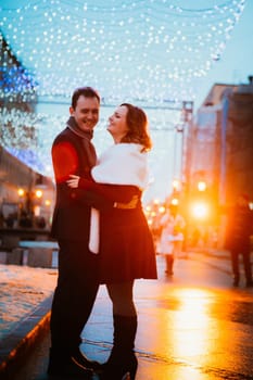 young couple on the background of the street in lanterns.