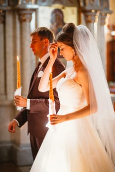 newlyweds wedding ceremony in the church,wedding ceremony, glans.