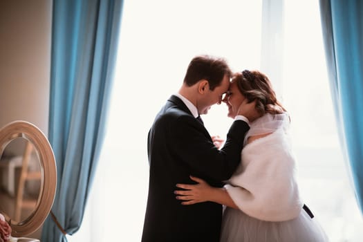 young bride and groom couple in a bright studio photo.