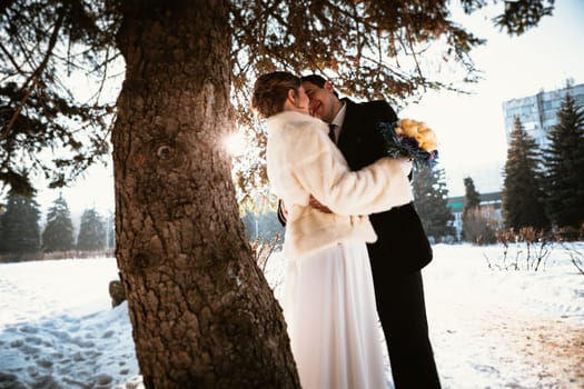 Lovers bride and groom on their winter wedding.