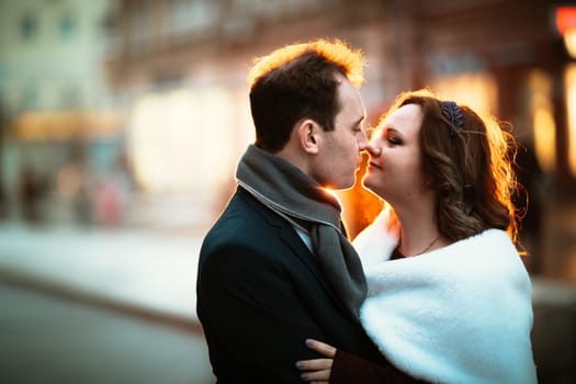 young couple on the background of the street in lanterns.