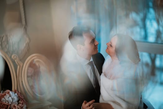 young bride and groom couple in a bright studio photo.