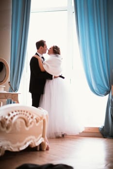young bride and groom couple in a bright studio photo.