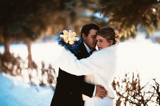 Winter bright wedding bride and groom couple.