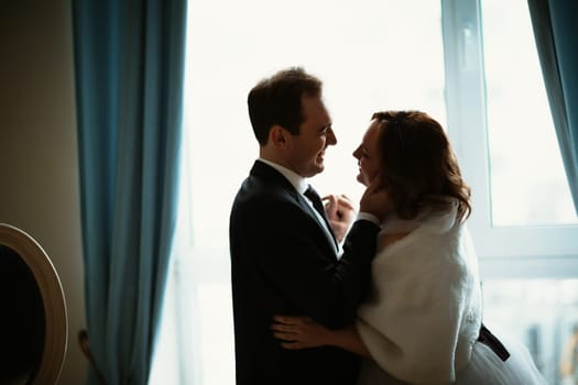 young bride and groom couple in a bright studio photo.