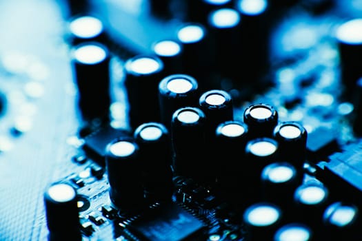 computer board capacitors blue color close up.