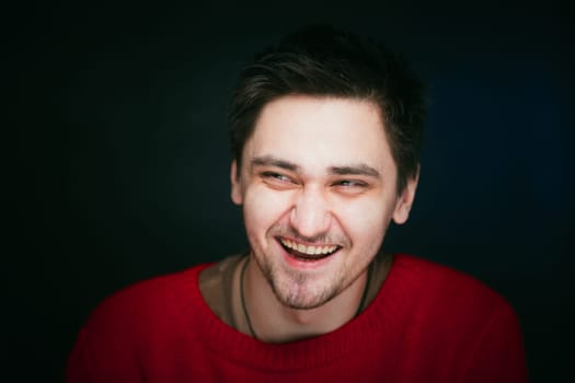 emotional young man photo in studio on blue background