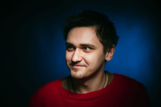 emotional young man photo in studio on blue background