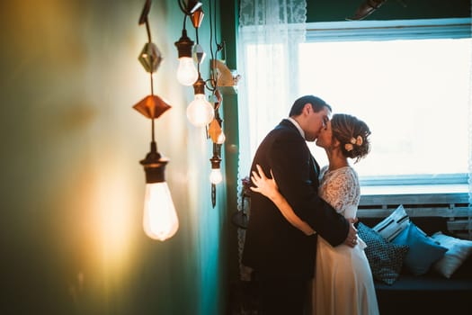 couple groom and bride in light studio.