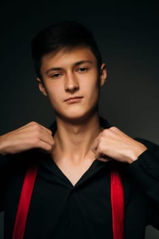 Portrait young guy on a dark studio.