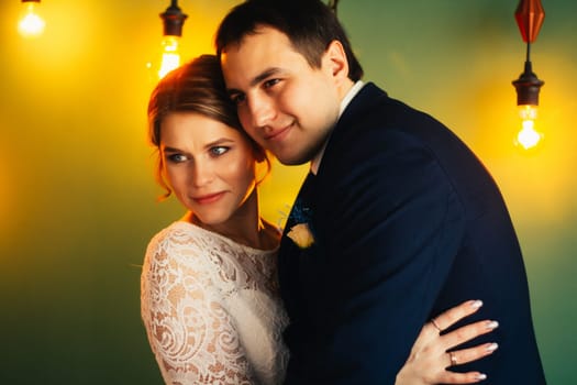 couple groom and bride in light studio.