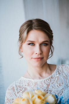 portrait of a bride near a window studio.