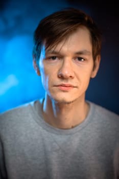portrait emotional young man on blue background.