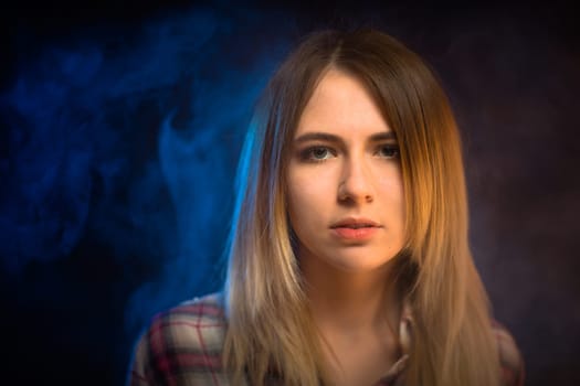 portrait smiling girl on blue background in studio.