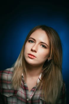 portrait smiling girl on blue background in studio.