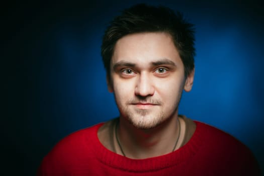 emotional young man photo in studio on blue background