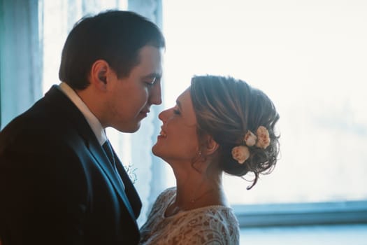 couple groom and bride in light studio.