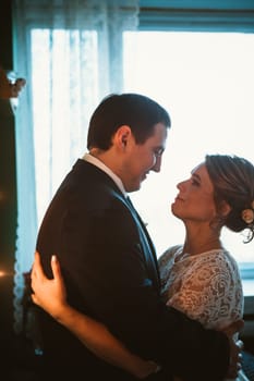 couple groom and bride in light studio.
