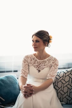 portrait of a bride near a window studio.