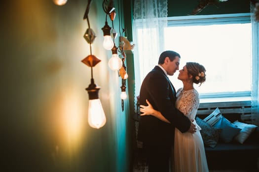 couple groom and bride in light studio.