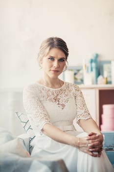 portrait of a bride near a window studio.