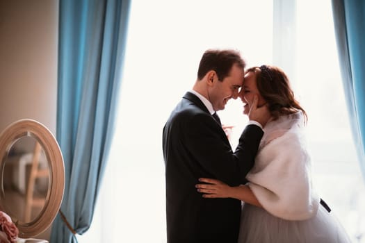 young bride and groom couple in a bright studio photo.