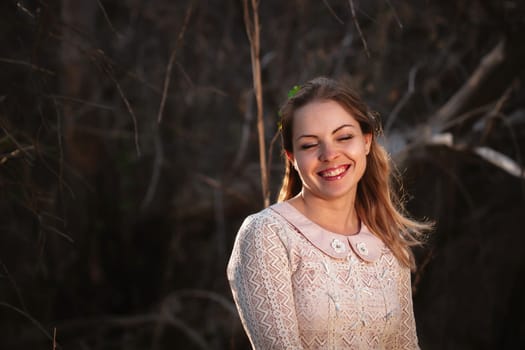portrait of a girl in a field on a sunset background.
