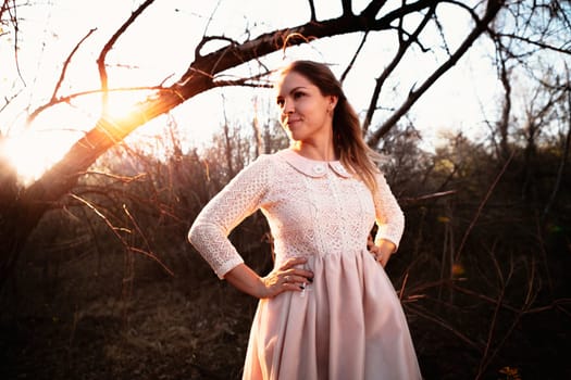 portrait of a girl in a field on a sunset background.