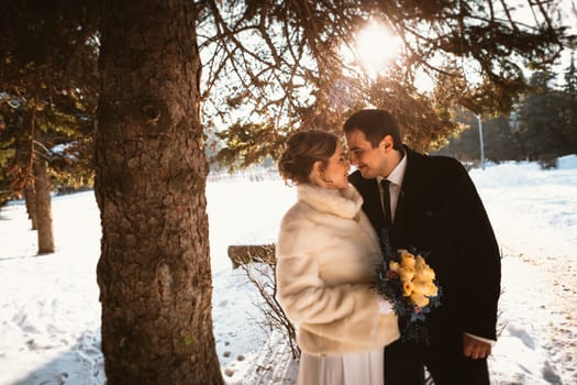 Lovers bride and groom on their winter wedding.