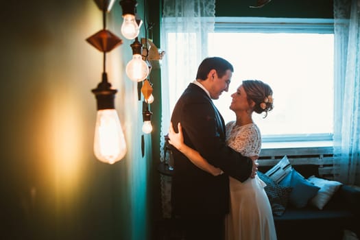 couple groom and bride in light studio.