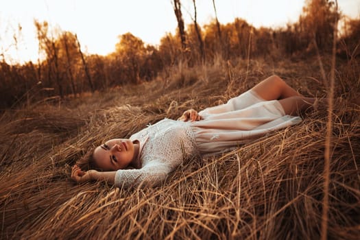 girl lying on the field on a sunset background.