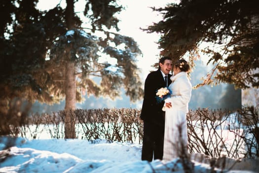 Winter bright wedding bride and groom couple.