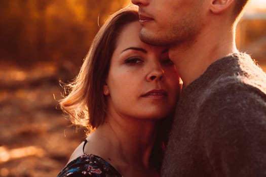 guy and girl in the field on the sunset background.