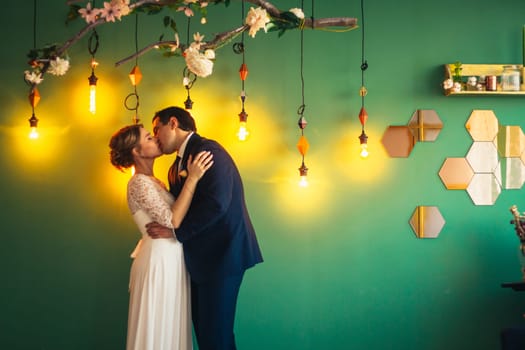 couple groom and bride in light studio.