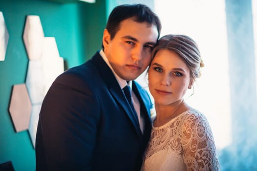 couple groom and bride in light studio.