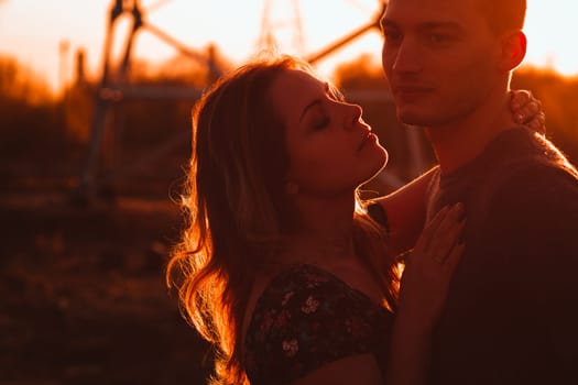 guy and girl in the field on the sunset background.