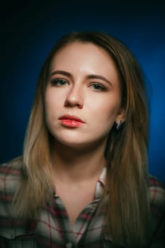 portrait smiling girl on blue background in studio.