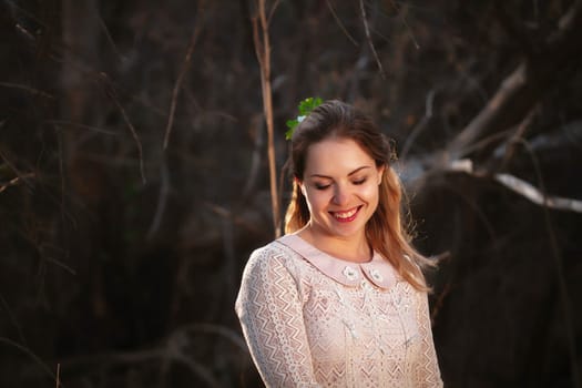 portrait of a girl in a field on a sunset background.