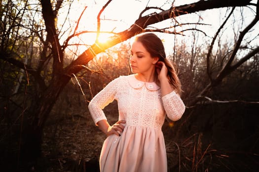 portrait of a girl in a field on a sunset background.