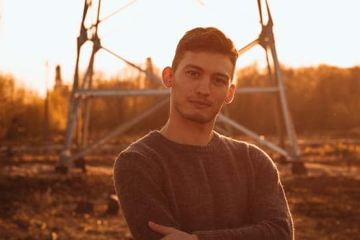 portrait of a guy in the field on a sunset background.