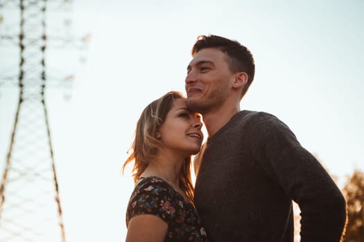 guy and girl in the field on the sunset background.