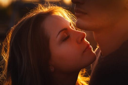 guy and girl in the field on the sunset background.