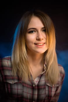 portrait smiling girl on blue background in studio.