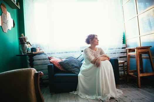 portrait of a bride near a window studio.